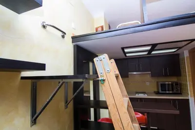 a loft bed in a tiny house at estudio marina puerto sherry in El Puerto de Santa María