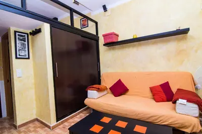 a living room with a couch with pillows on it at estudio marina puerto sherry in El Puerto de Santa María
