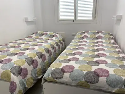 a bedroom with two twin beds in a room at Apartamento Retama Golf I in Chiclana de la Frontera