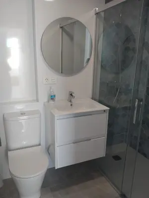 a bathroom with a toilet and a sink and a shower at Apartamento Retama Golf I in Chiclana de la Frontera