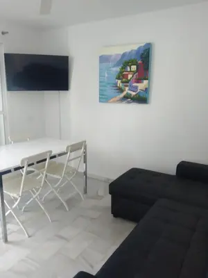 a living room with a couch and a table at Apartamento Retama Golf I in Chiclana de la Frontera