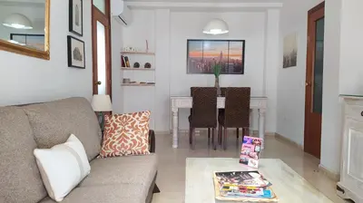 a living room with a couch and a table at Sherryflat Mérito - Parking in Jerez de la Frontera