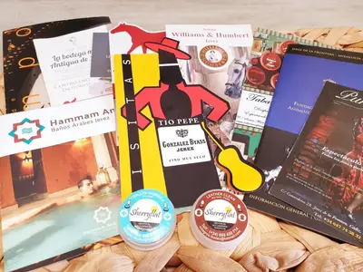 a bunch of books and pamphlets on a table at Sherryflat Mérito - Parking in Jerez de la Frontera