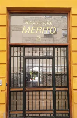 a storefront window of a restaurant merrico at Sherryflat Mérito - Parking in Jerez de la Frontera