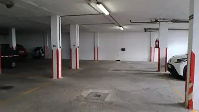 an empty parking garage with a car parked in it at Sherryflat Mérito - Parking in Jerez de la Frontera