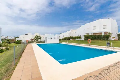 a large swimming pool in front of a building at Duplex Camino del Tejar in Conil de la Frontera