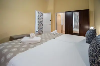 a bedroom with a large bed with two towels on it at Apartamento Casa Senorial Cadiz in Cádiz