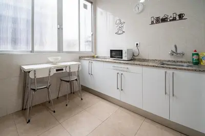 a kitchen with white cabinets and a sink at Apartamento Casa Senorial Cadiz in Cádiz