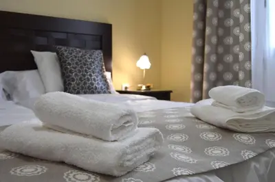 a bed with towels sitting on top of it at Apartamento Casa Senorial Cadiz in Cádiz