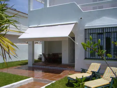 a white awning on the side of a house at Casa Sargo in Chiclana de la Frontera