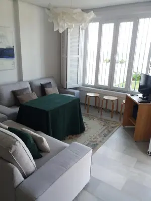 a living room with a couch and a table at Casa Sargo in Chiclana de la Frontera
