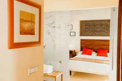 a bedroom with a bed with red pillows at Loft del Arte in Cádiz