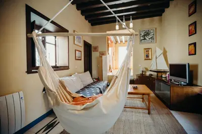 a hanging hammock in a living room with a couch at Loft del Arte in Cádiz