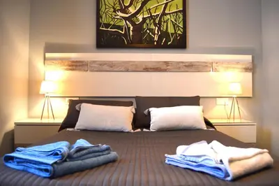 a bedroom with a bed with towels on it at Apartamento El Mirador de Cadiz in Cádiz