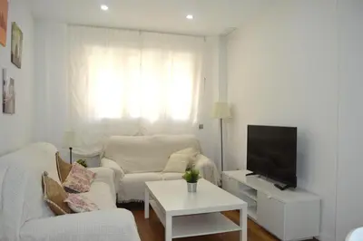 a living room with a couch and a tv at Apartamento Recreo Cadiz in Cádiz