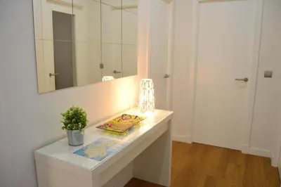 a bathroom with a white counter and a mirror at Apartamento Recreo Cadiz in Cádiz