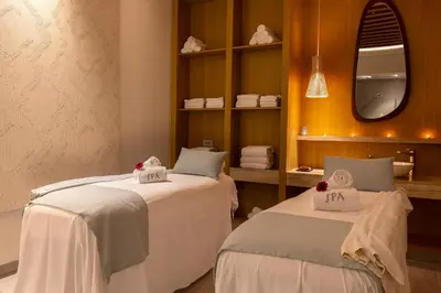 a dining room with tables and chairs and windows at Hipotels Barrosa Palace & Spa in Chiclana de la Frontera