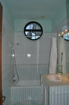 a bathroom with a sink and a shower and a mirror at Villa las Redes in El Puerto de Santa María