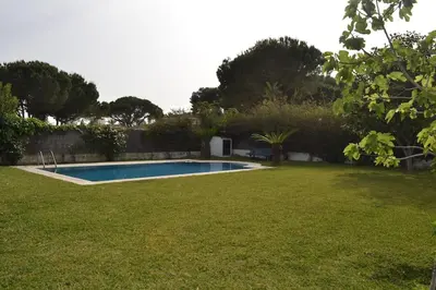 a swimming pool in the yard of a house at Villa las Redes in El Puerto de Santa María