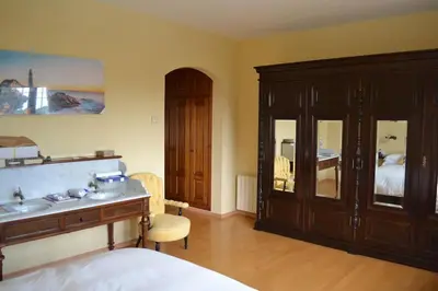 a bedroom with a bed and a sink and a cabinet at Villa las Redes in El Puerto de Santa María