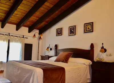 a bedroom with a large bed in a room at Cortijo Mesa de la Plata in Arcos de la Frontera