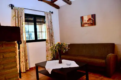 a living room with a couch and a table at Cortijo Mesa de la Plata in Arcos de la Frontera