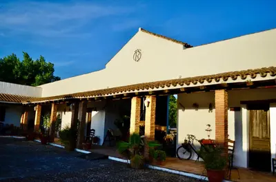a white house with a bike parked outside of it at Cortijo Mesa de la Plata in Arcos de la Frontera
