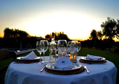 a table with wine glasses and napkins on it at Cortijo Mesa de la Plata in Arcos de la Frontera