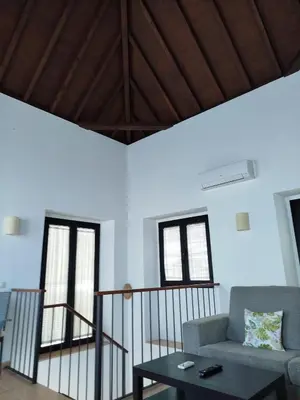 a living room with a couch and a table at Apartamentos Fariñas 11 in Sanlúcar de Barrameda