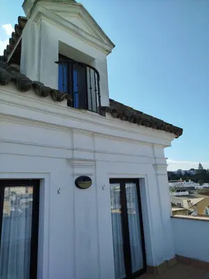 a white building with a window on top of it at Apartamentos Fariñas 11 in Sanlúcar de Barrameda