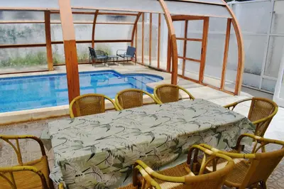 a patio with a table and chairs next to a pool at Sancti Petri House in Chiclana de la Frontera