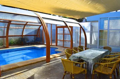 a patio with a table and chairs next to a pool at Sancti Petri House in Chiclana de la Frontera