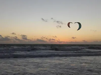 a couple of kites flying in the sky over the ocean at Sancti Petri House in Chiclana de la Frontera