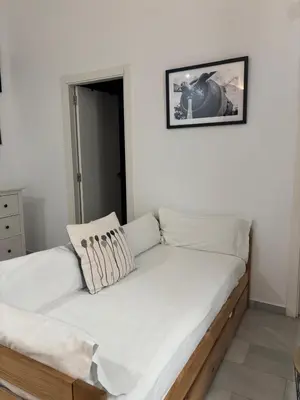 a bed in a room with white walls at ISA Cádiz in Cádiz