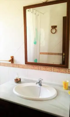 a bathroom sink with a mirror and a sink at Villa Juan in Conil de la Frontera