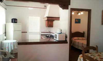 a kitchen with a counter top and a microwave at Villa Juan in Conil de la Frontera