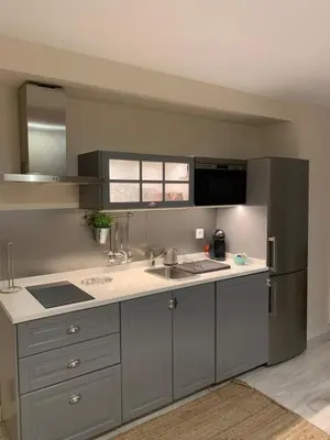 a kitchen with a sink and a refrigerator at Hidden Gem Playa Helios con Ascensor & Parking in Cádiz