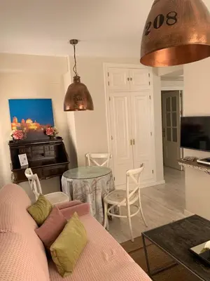a living room with a couch and a table at Hidden Gem Playa Helios con Ascensor & Parking in Cádiz