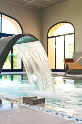 a water fountain in a swimming pool at Barceló Jerez Montecastillo & Convention Center in Jerez de la Frontera