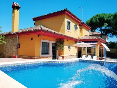 a house with a swimming pool in front of a house at VillaLaJaraCom CHALET CON PISCINA, PROHIBIDAS DESPEDIDAS GRUPOS Y FIESTAS, SOLO FAMILIAS RECEPCION POR EL PROPlETARIO in El Puerto de Santa María