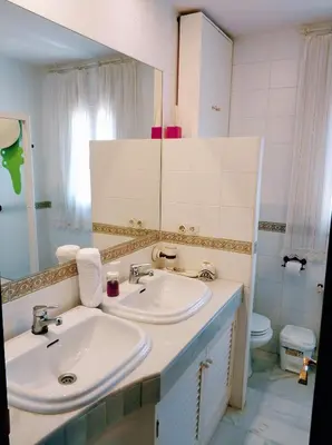 a bathroom with a sink and a toilet at VillaLaJaraCom CHALET CON PISCINA, PROHIBIDAS DESPEDIDAS GRUPOS Y FIESTAS, SOLO FAMILIAS RECEPCION POR EL PROPlETARIO in El Puerto de Santa María
