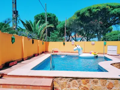 a pool with a inflatable swan in the water at VillaLaJaraCom CHALET CON PISCINA, PROHIBIDAS DESPEDIDAS GRUPOS Y FIESTAS, SOLO FAMILIAS RECEPCION POR EL PROPlETARIO in El Puerto de Santa María