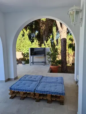 an archway with a blue mattress on a patio with a piano at Roche Pinos Verdes in Roche