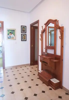 a bathroom with a wooden mirror and a tiled floor at Roche Pinos Verdes in Roche