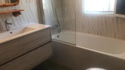 a bathroom with a tub and a sink and a bath tub at Roche Pinos Verdes in Roche