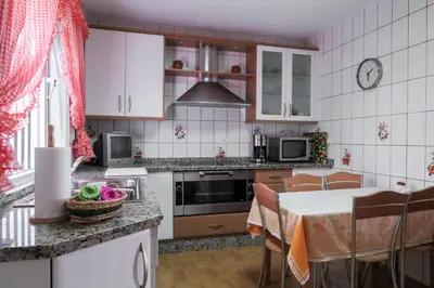 a kitchen with a table and a dining room at Roche Pinos Verdes in Roche