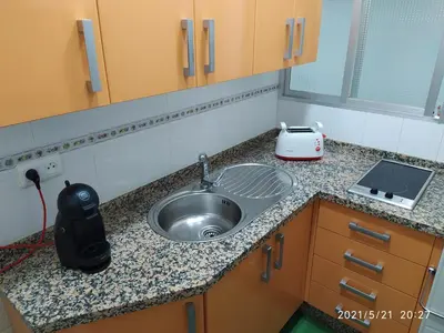a kitchen counter with a sink and a toaster at Los Tres Girasoles in Cádiz