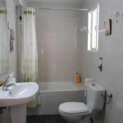 a bathroom with a toilet and a sink and a tub at Atico Soleado in Cádiz