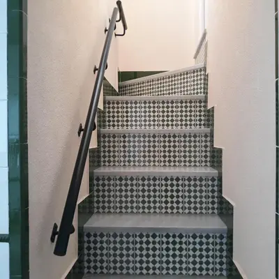 a set of stairs with a metal hand rail at Atico Soleado in Cádiz