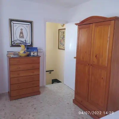 a room with a wooden cabinet and a dresser at Atico Soleado in Cádiz